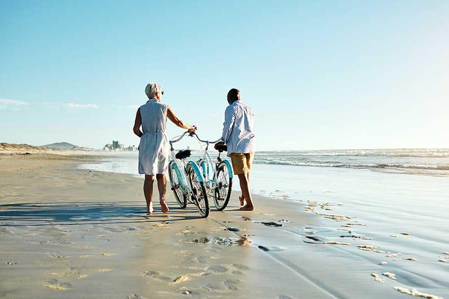 Individuals walking on a beach